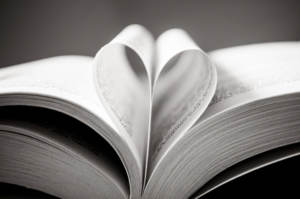A open book with pages tucked to form a heart representing choosing the right readings