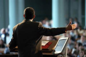speaker raising arm in front of pulpit
