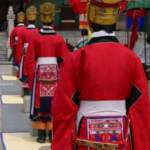 Koreans dressed in traditional red wedding garb in line for ceremony