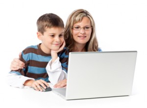 boy and mother viewing laptop against white background