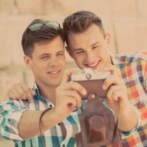A gay couple taking a selfie together