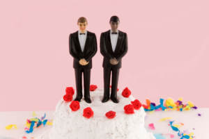 Two groom figures on a wedding cake