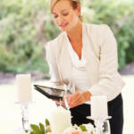 Wedding Planner Checking Table Decorations In Marquee