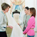 Gay-friendly wedding vendor helping young women pick bridal fabric