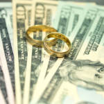 Wedding rings sitting on money