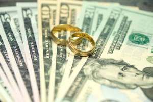 Wedding rings sitting on money