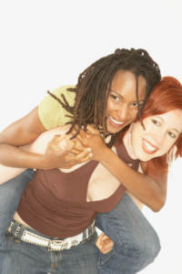 Studio shot of interracial female couple playing and dealing with parents