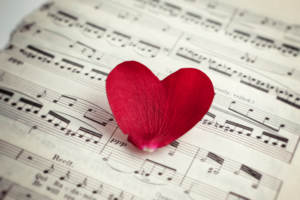 A flower petal heart on sheet music representing a wedding that's uniquely you