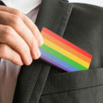 man holding rainbow business card