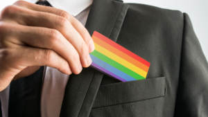 man holding rainbow business card