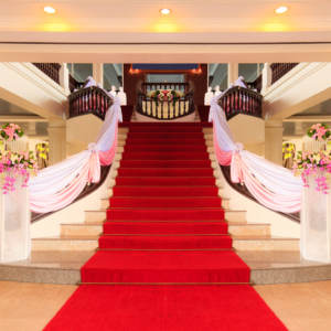 Decorated staircase with a red carpet for choosing a wedding ceremony theme