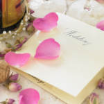 wedding invitation with flower petals on it