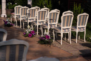 Chairs set along the aisle for a wedding ceremony as seating advice