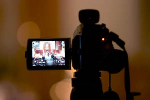 Video camera recording a wedding ceremony by photographers and videographers