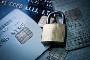 A padlock resting on credit cards indicating identity security