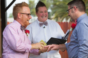 A newlywed couple with a friend to officiate