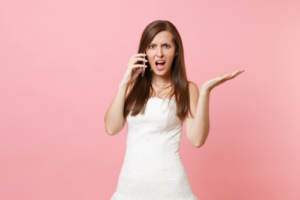 A bride on the telephone with members of her wedding party