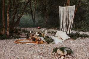 A rocky riverbank with decorations; a popular venue for eloping couples