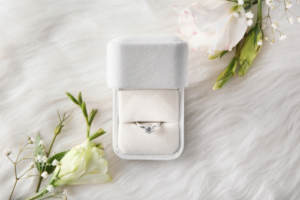 A well-maintained engagement ring in a white presentation box