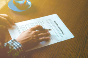 A wedding vendor contract being reviewed before signing