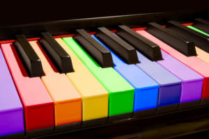 A rainbow-keyed piano, waiting to play wedding songs