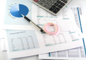 financial documents with a pen and bracelet