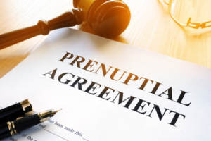 A prenuptial agreement on a table with pen and gavel 