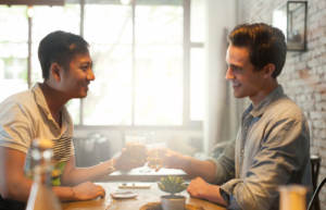A gay couple setting healthy boundaries while at a restaurant.