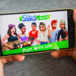 Playing The Sims Mobile game on a smartphone