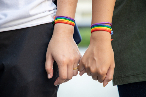 A gay couple in a strong marriage holding hands.