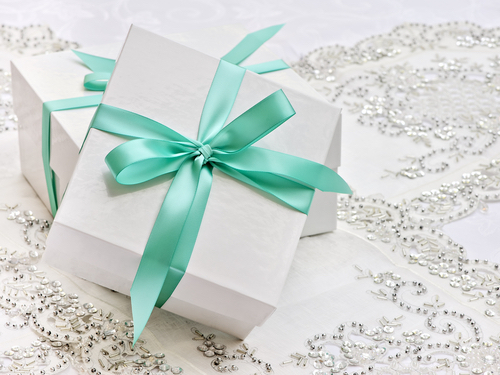 Two wedding gift boxes tied with a teal bow