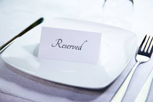 Reserved card on a dinner plate is different from escort cards