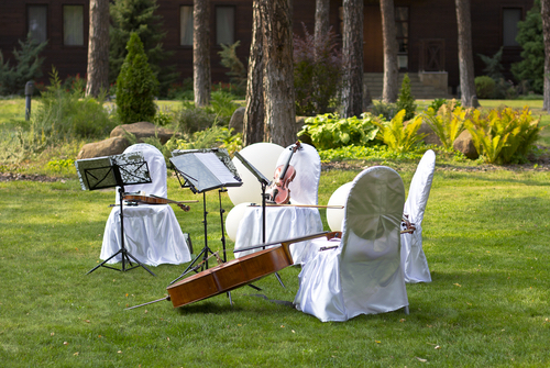 string quartet instruments set up outside are an option when picking your wedding music