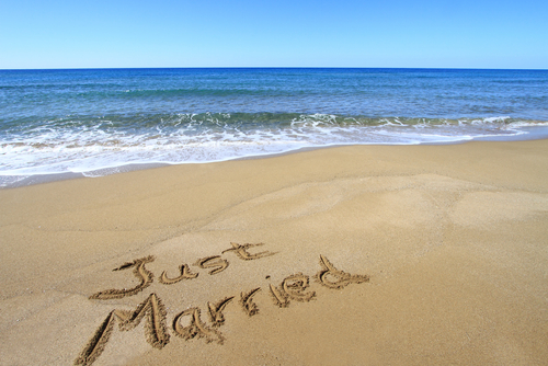 Just married written in the sand on a beach