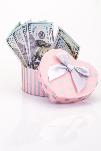 Heart box with 6 $100 bills in it representing being budget-conscious for your wedding ceremony