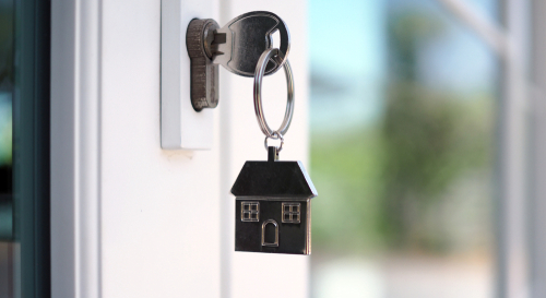 A key in a door lock with a home key chain attached