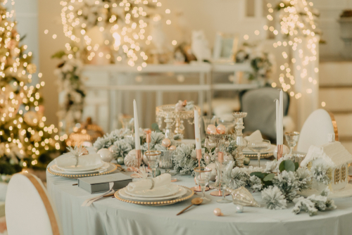 Winter wedding essentials displayed on a table with string lights in the background