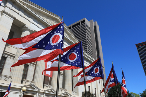 Ohio state flags waving outside of statehouse