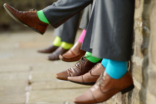 Line of people wearing colored dress socks for a wedding