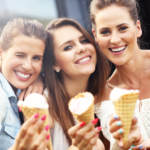 Three women eating ice cream cones at an engagement party