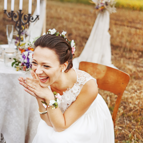 A bride laughing at humor inserted into her wedding