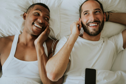 gay couple listing to music to pick their first dance song