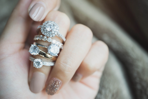 engagement rings on a hand when learning how to protect and care for your engagement ring.