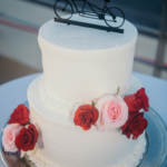 Wedding cake with flowers and bike cake topper