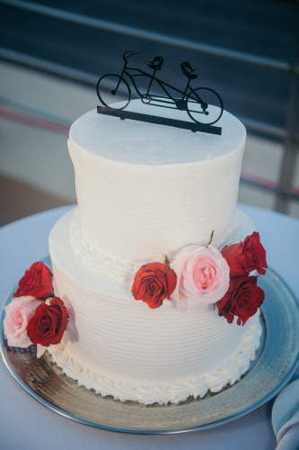 Wedding cake with flowers and bike cake topper