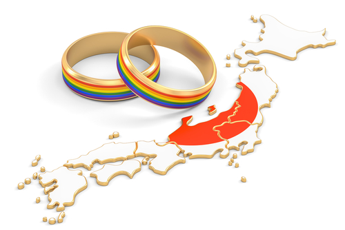 rainbow wedding rings representing marriage equality next to depiction of Japan