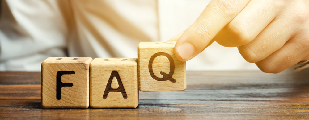 Wood blocks spelling FAQ representing providing answers for your guests