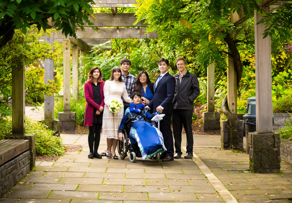 Bride and groom together with disabled family member at their inclusive wedding