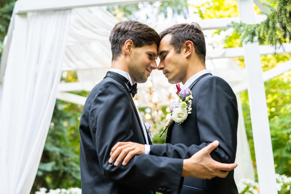 LGBTQ couple thinking about wedding insurance