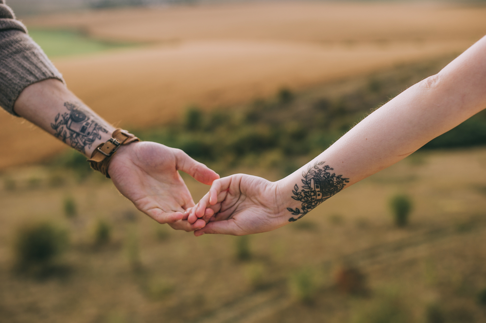 A couple with matching tattoos are one of many engagement ring alternatives out there